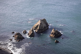 Aerial View of Rocky Sea Stacks in Blue Ocean Waters