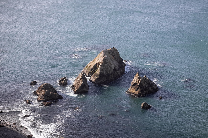Aerial View of Rocky Sea Stacks in Blue Ocean Waters