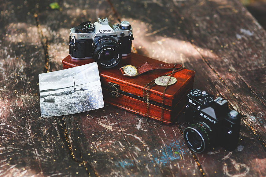 Vintage Cameras and Wooden Box on Rustic Table