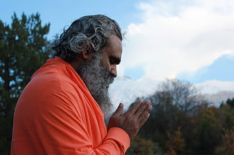Hindu Monk Praying in Nature with Mountains
