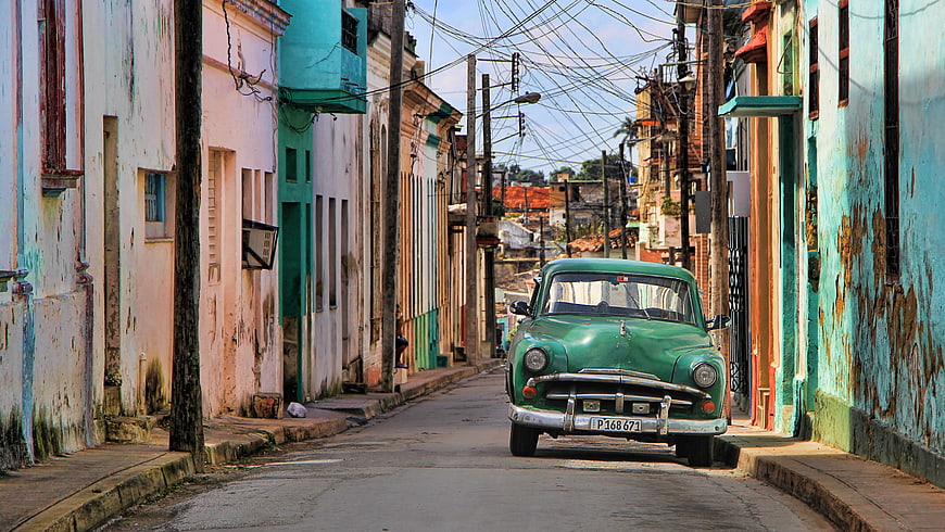 Vintage Green Car Parked on Colorful Havana Street
