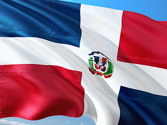 Dominican Republic Flag Waving Against Blue Sky