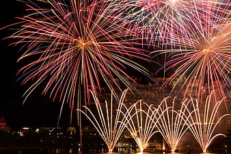 Colorful Fireworks Display Over City Skyline at Night