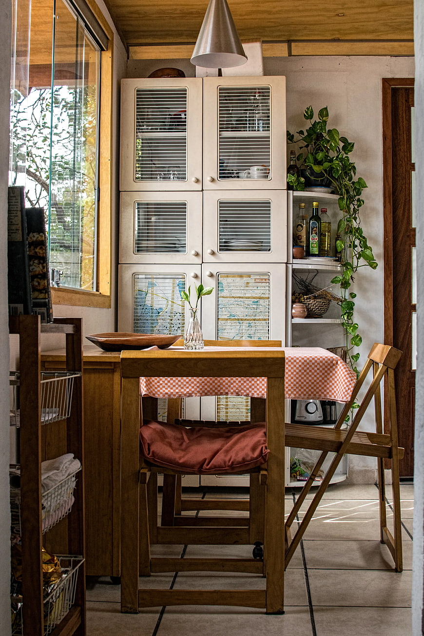 Cozy rustic kitchen interior with wooden table and vintage cabinets