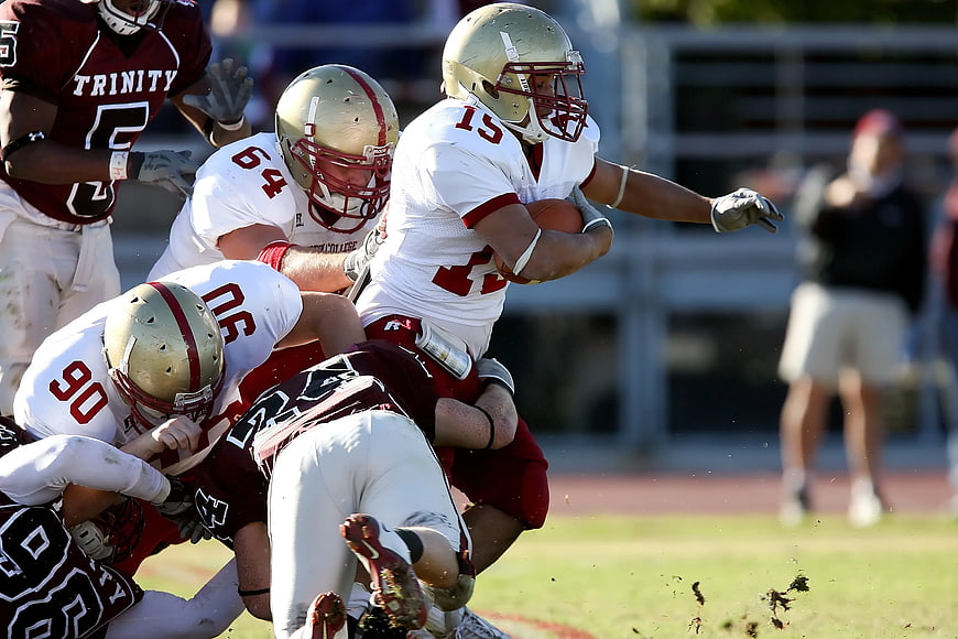 American Football Tackle Action Shot on Grass Field