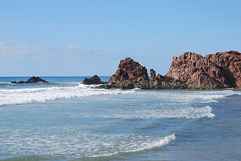 Red Rock Formations on a Sunny Coastal Beach