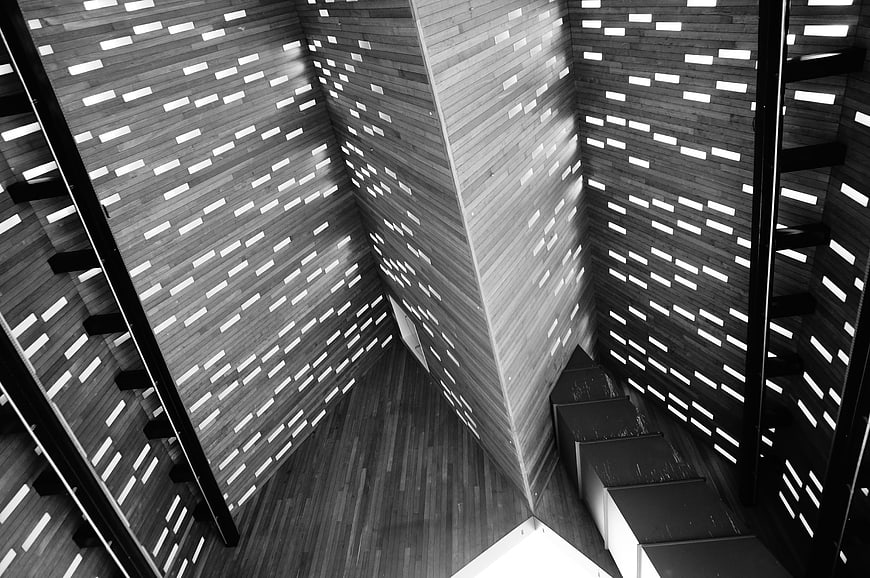 Black and white architectural staircase with light patterns
