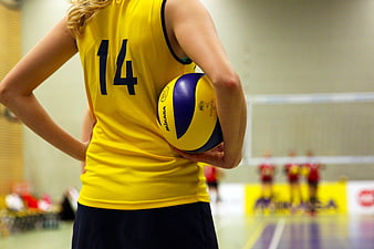 Volleyball Player Holding Ball in Yellow Jersey