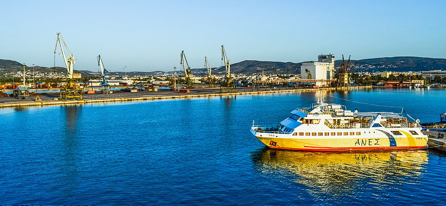 Yellow and white ferry boat docked in Volos harbor, Greece