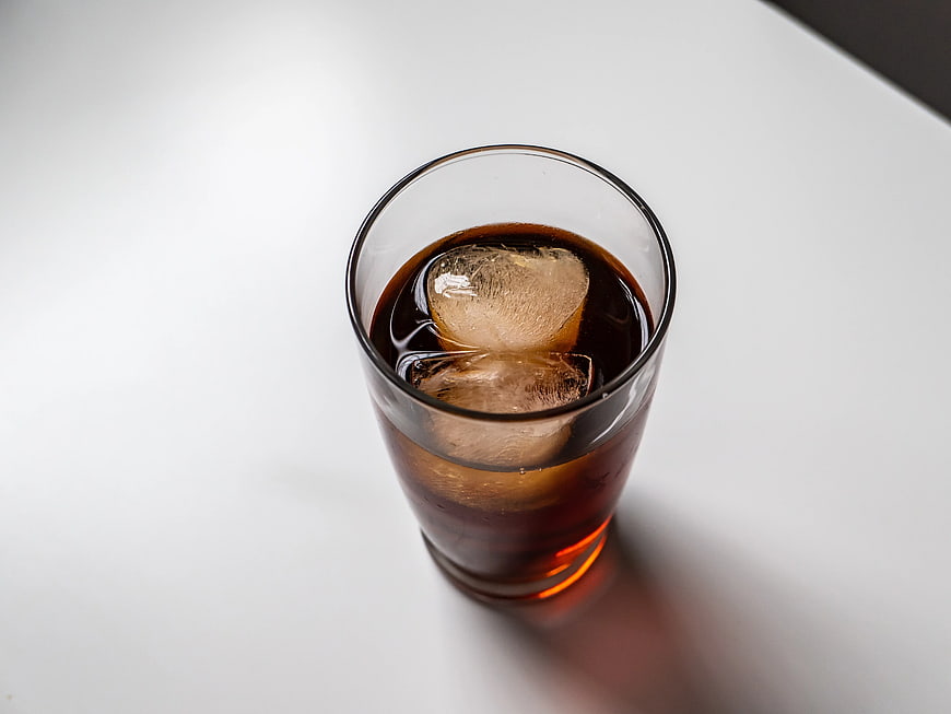 Top View of Iced Coffee with Ice Cubes on White Surface