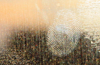 Macro fingerprint on dirty glass window with textured background