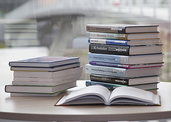 Stacks of Technology Books on Table by Window