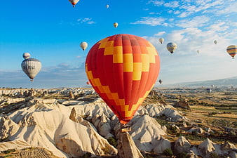 Hot Air Balloons Flying Over Cappadocia Landscape