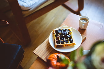 Autumn waffle with chocolate and coffee on wooden table