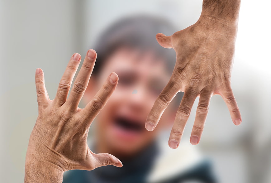Adult Hands Threatening Blurred Child Face Concept