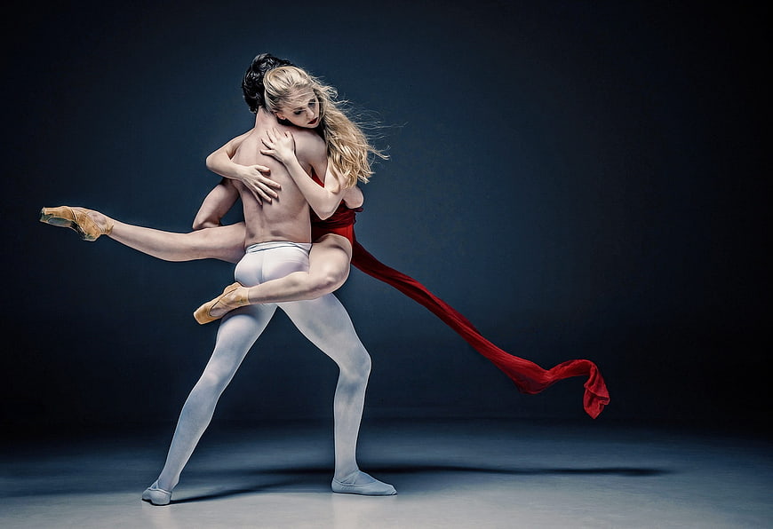 Ballet Dancers in Dramatic Embrace with Red Fabric