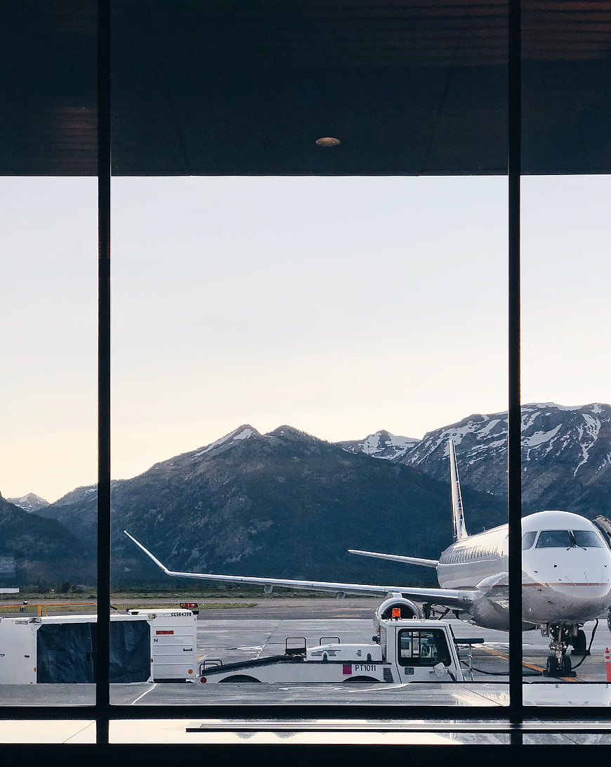 Airplane at Airport Terminal with Mountain View