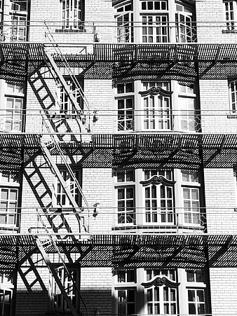Black and white fire escape on brick building facade
