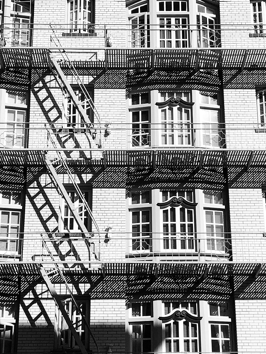 Black and white fire escape on brick building facade