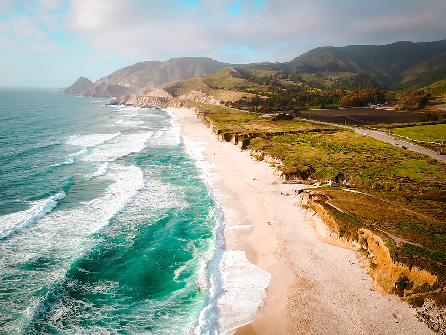 Aerial View of Turquoise Ocean Waves Crashing on Sandy Beach