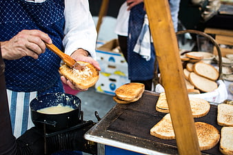 Traditional Czech garlic bread being prepared at a street market