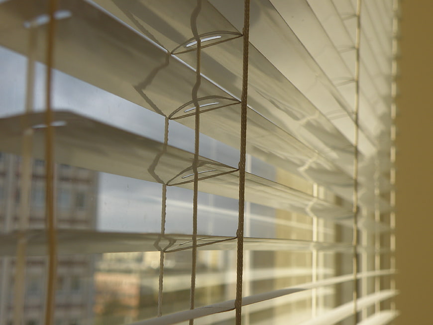 Close-up of Venetian Blinds with Soft Natural Light and Urban View