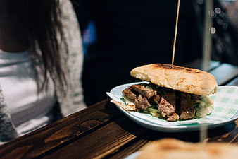 Close-up of Argentinian beef steak sandwich on wooden table