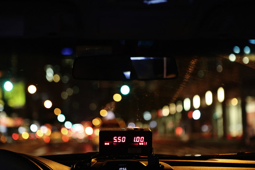 Taxi Meter Display at Night with City Bokeh Lights