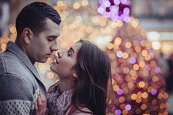 Romantic Couple with Christmas Lights Bokeh Background