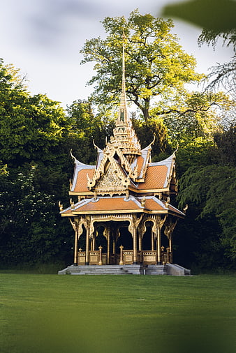 Ornate Thai Pavilion With Golden Spire In Lush Green Park