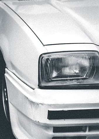 Close-up of vintage car headlight in black and white