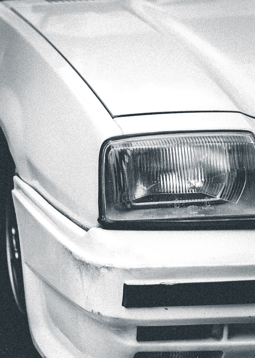 Close-up of vintage car headlight in black and white