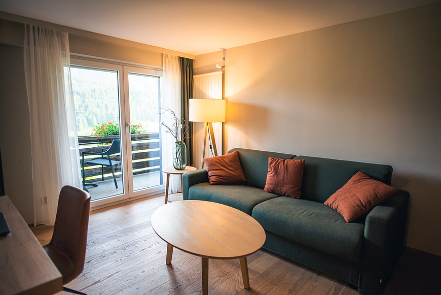 Modern Living Room with Green Sofa and Balcony View