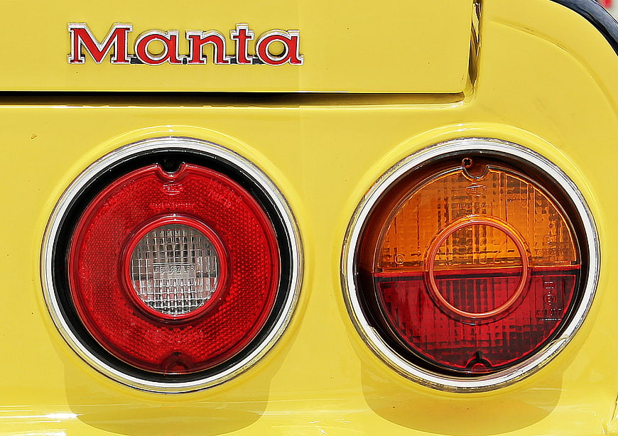 Close-up of yellow Manta car rear lights and emblem