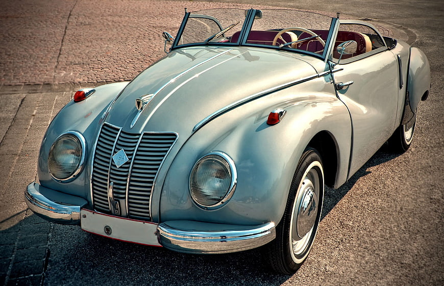Vintage Light Blue Convertible Car on Cobblestone Street