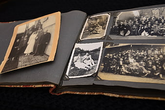 Open vintage photo album with old black and white family photographs