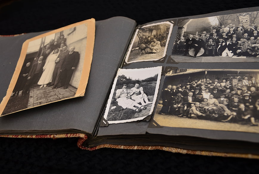 Open vintage photo album with old black and white family photographs