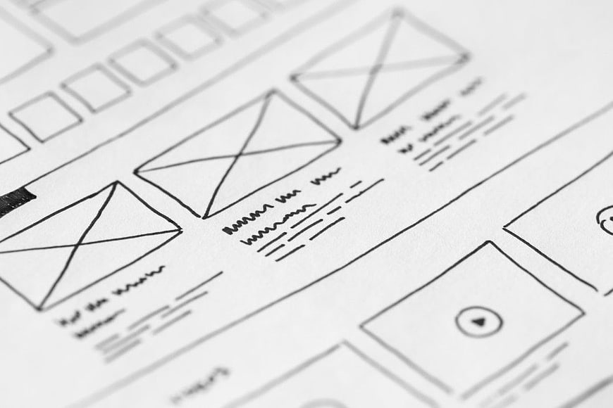 Hand-drawn wireframe sketch on paper for web design