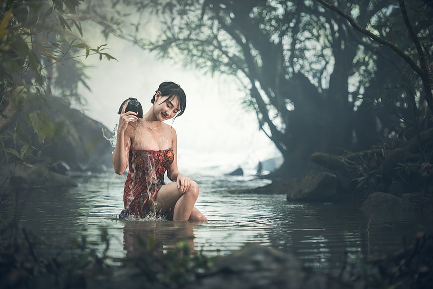 Young Asian Woman Bathing In Misty Forest River