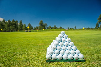 Pyramid Stack of Golf Balls on Green Course