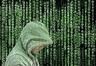 Hacker in Hoodie with Green Digital Code Overlay