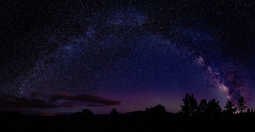 Milky Way Galaxy Over Silhouetted Mountain Landscape at Night
