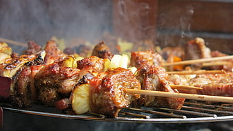 Close-up of Grilled Meat Skewers with Pineapple on BBQ Grill