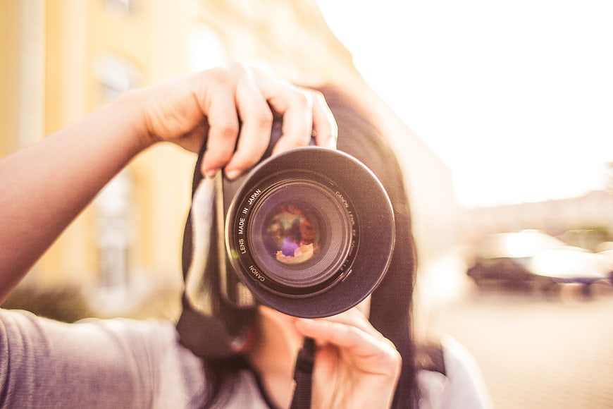 Woman Photographer Holding DSLR Camera Lens Closeup