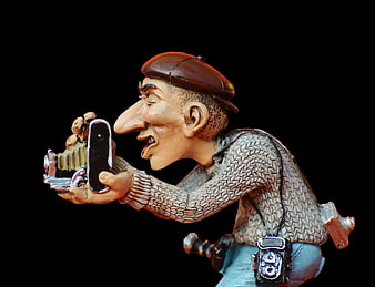 Caricature figurine of photographer taking selfie with smartphone