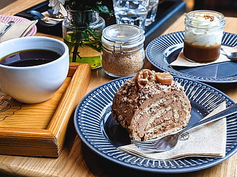 Chocolate roll cake with coffee and dessert in a cafe