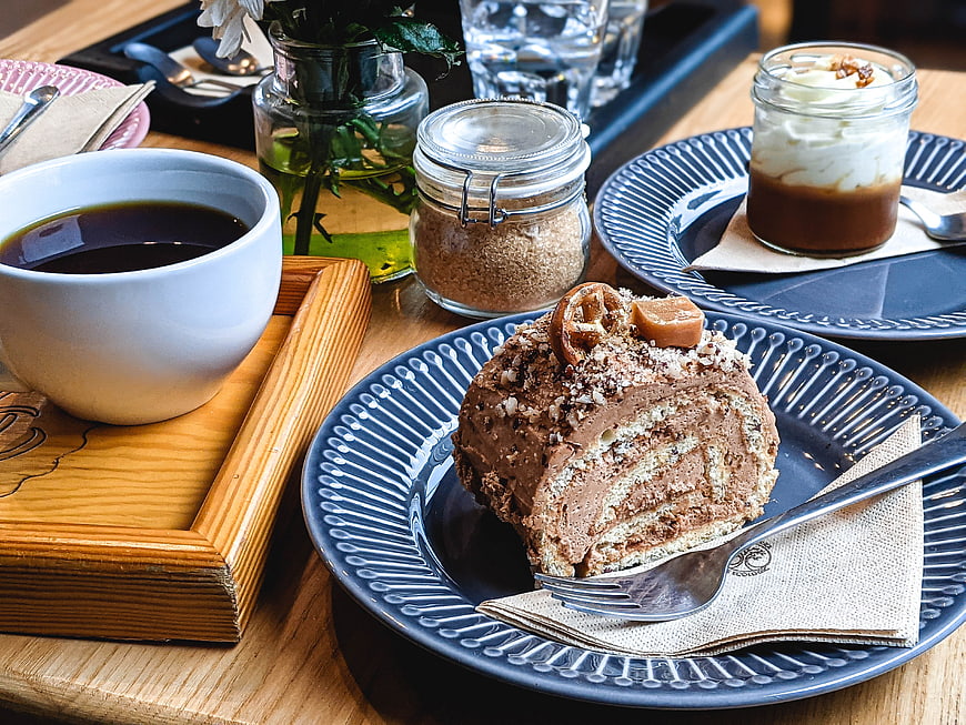 Chocolate roll cake with coffee and dessert in a cafe