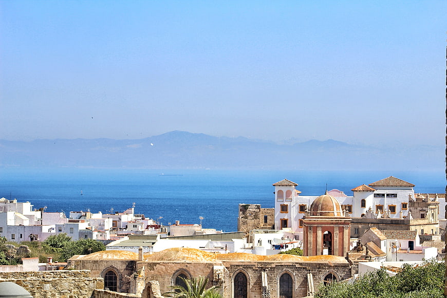 White Mediterranean Town Overlooking Blue Sea and Distant Mountains
