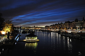 Stockholm Waterfront Night Scene With Illuminated Pavilion And City Skyline