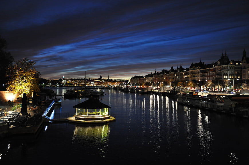 Stockholm Waterfront Night Scene With Illuminated Pavilion And City Skyline
